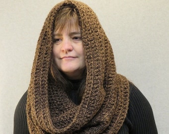 May include: A brown crocheted cowl neck scarf with a long, loose fit. The scarf is made of a soft, chunky yarn and is perfect for keeping warm in the winter.