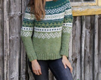 May include: A green, white, and blue knitted sweater with a geometric pattern. The sweater has a crew neck and long sleeves.