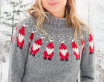 May include: A gray sweater with a high neck featuring a pattern of red and white Santa Claus figures. The sweater has long sleeves and is set against a snowy background. The brand logo and website address are visible at the bottom.