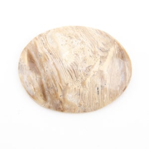 May include: A smooth, oval-shaped stone with a natural, swirling pattern of light brown and cream colors. The stone has a polished appearance and is set against a white background.