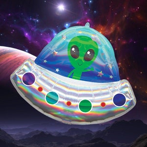 May include: A holographic silver and blue alien spaceship balloon with a green alien inside. The balloon is floating in front of a dark blue background with stars and planets.