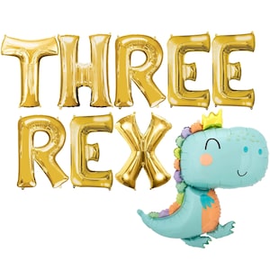 May include: Gold foil letter balloons spelling "THREE REX" with a blue dinosaur balloon with a crown.