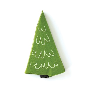 May include: A green paper Christmas tree with white wavy lines drawn on it. The tree is folded into a triangle shape and has a black base.