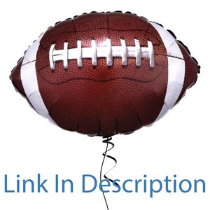 May include: A brown and white football-shaped balloon with a black ribbon.