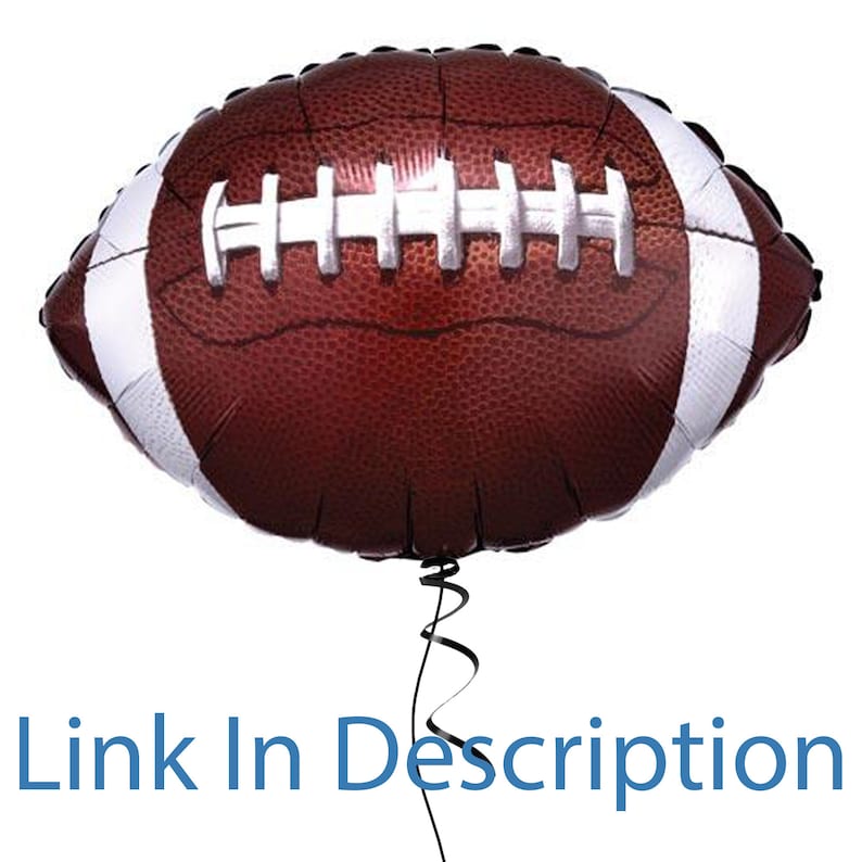 May include: A brown and white football-shaped balloon with a black ribbon.