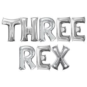 May include: Silver foil balloons spelling out "THREE REX".