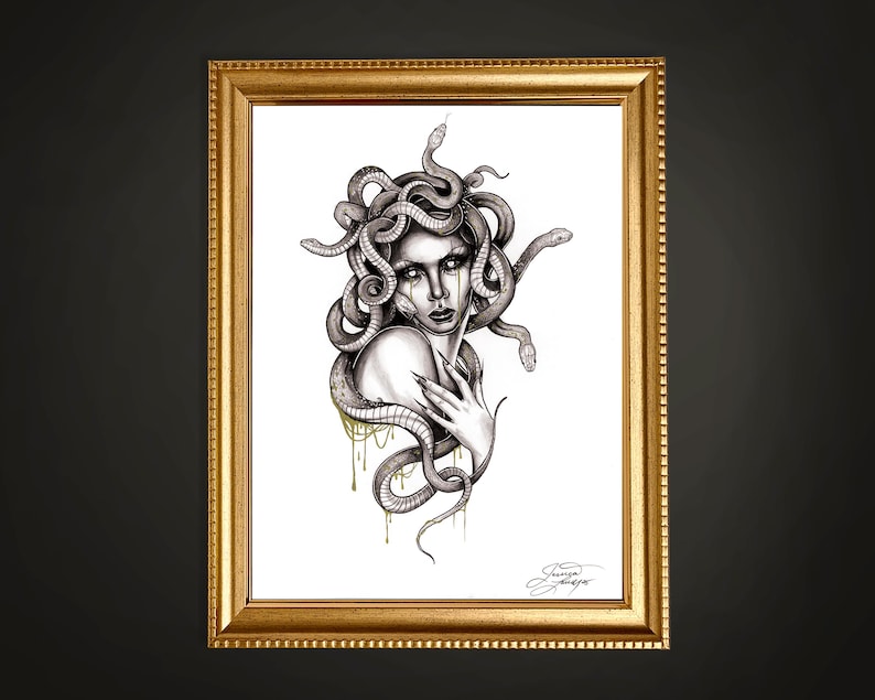 May include: A framed art print featuring a detailed black and white illustration of Medusa. The artwork depicts Medusa with snakes for hair, with gold accents. The print is in a gold frame, creating a striking contrast against the dark background.