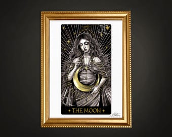 May include: A black and white tarot card illustration of The Moon card. The card features a woman with long dark hair holding a crescent moon in her hands. The background is black with gold stars and a golden sunburst.