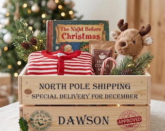 May include: A wooden crate labeled NORTH POLE SHIPPING SPECIAL DELIVERY FOR DECEMBER and DAWSON containing a book titled The Night Before Christmas, a red and white striped shirt, a plush reindeer, a packet of hot cocoa mix, and a candy cane.