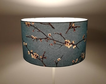 Round lampshade printed fabric inspired by Japanese cherry tree Branches in white flowers on a sky blue background