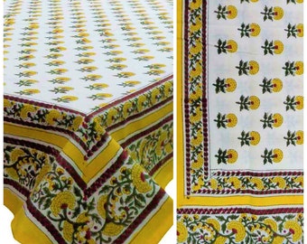 May include: A white tablecloth with a yellow and green floral pattern. The tablecloth has a yellow border with a maroon and white trim.