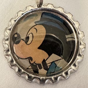 Mickey Mouse Left Looking Face Silver Metal Bottle Cap Keychain with a Blue Tassel Charm made from a Vintage 1970s Disney Magazine
