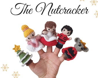May include: A set of five finger puppets featuring characters from the Nutcracker ballet. The puppets include Clara, the Nutcracker, the Mouse King, a Christmas tree, and a ballerina. The puppets are made of crocheted yarn in various colors, including red, green, white, and brown.
