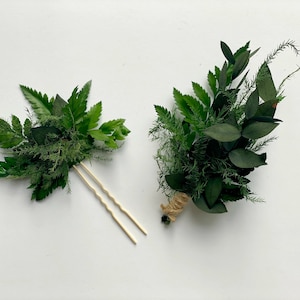 May include: Two green floral arrangements, one with a wooden hairpin and the other tied with twine.