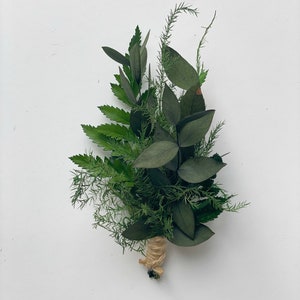 May include: A small bouquet of green foliage tied with twine. The bouquet includes ferns, eucalyptus, and other greenery.