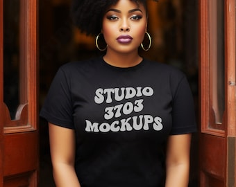 May include: A woman wearing a black t-shirt with the text "STUDIO 3703 MOCKUPS" printed in white. She has curly black hair and is standing in a doorway.