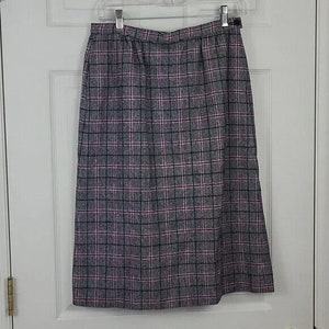 May include: A grey and pink plaid skirt with a button fastening. The skirt is knee-length and has a straight silhouette.