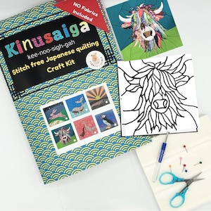 May include: A Kinusaiga stitch-free Japanese quilting craft kit box with a blue and yellow wave pattern, featuring a colorful highland cow image, a black and white line art template, a blue handled craft tool, scissors, and sewing pins.