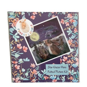 May include: A felted picture kit featuring a hare gazing at the stars under a full moon. The kit is packaged in a purple box with a floral design and the text "Frankie & Sidney" and "Star Gazer Hare Felted Picture Kit".