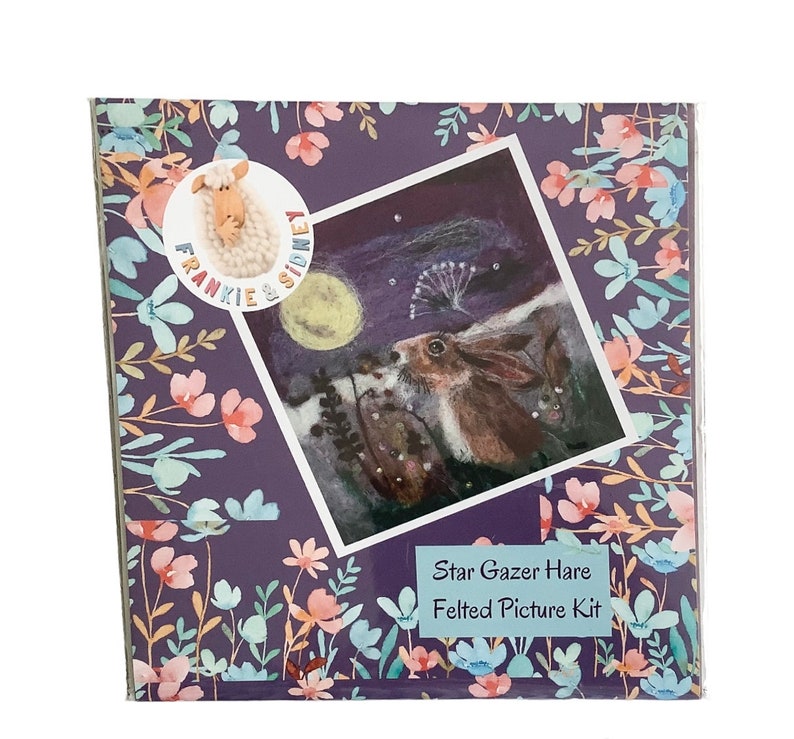 May include: A felted picture kit featuring a hare gazing at the stars under a full moon. The kit is packaged in a purple box with a floral design and the text "Frankie & Sidney" and "Star Gazer Hare Felted Picture Kit".