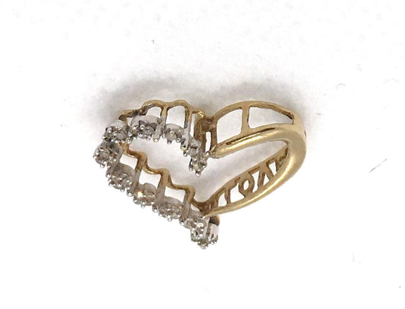 May include: A gold heart-shaped ring with a row of small diamonds around the edge.
