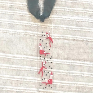 May include: A white ceramic mug with a black handle and the text "But First, Coffee" in a black, bold font. The mug is on a white surface. The mug is approximately 10 cm tall.