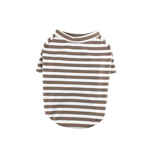 May include: A brown and white striped dog shirt with short sleeves.