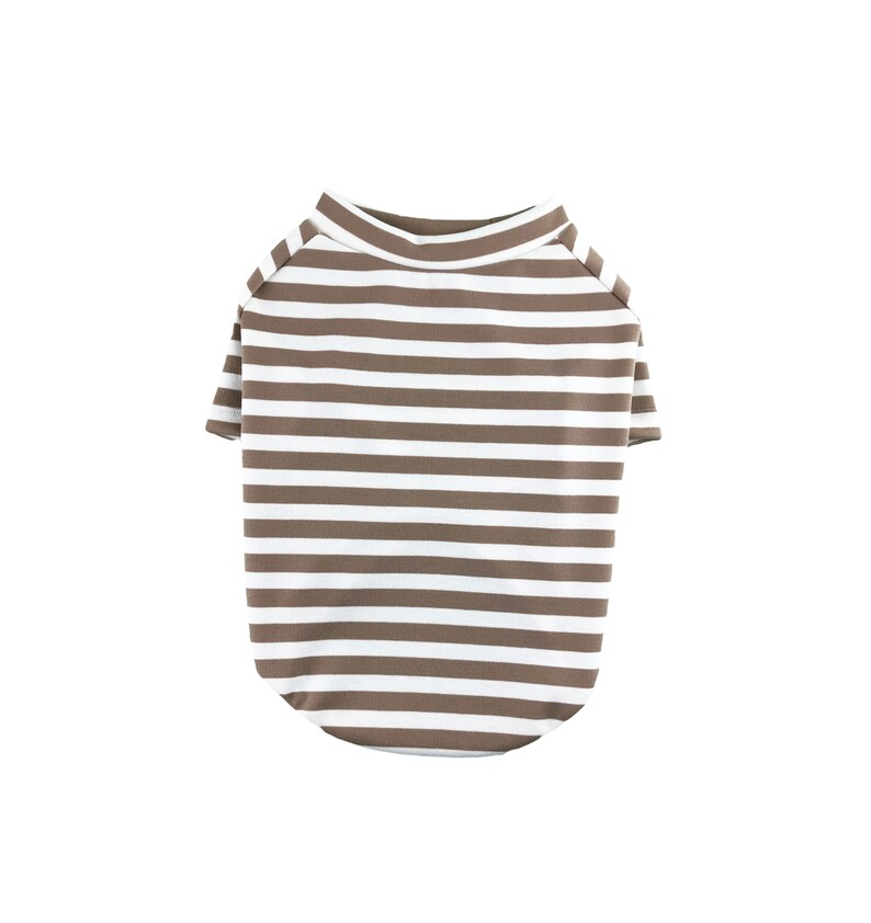 May include: A brown and white striped dog shirt with short sleeves.