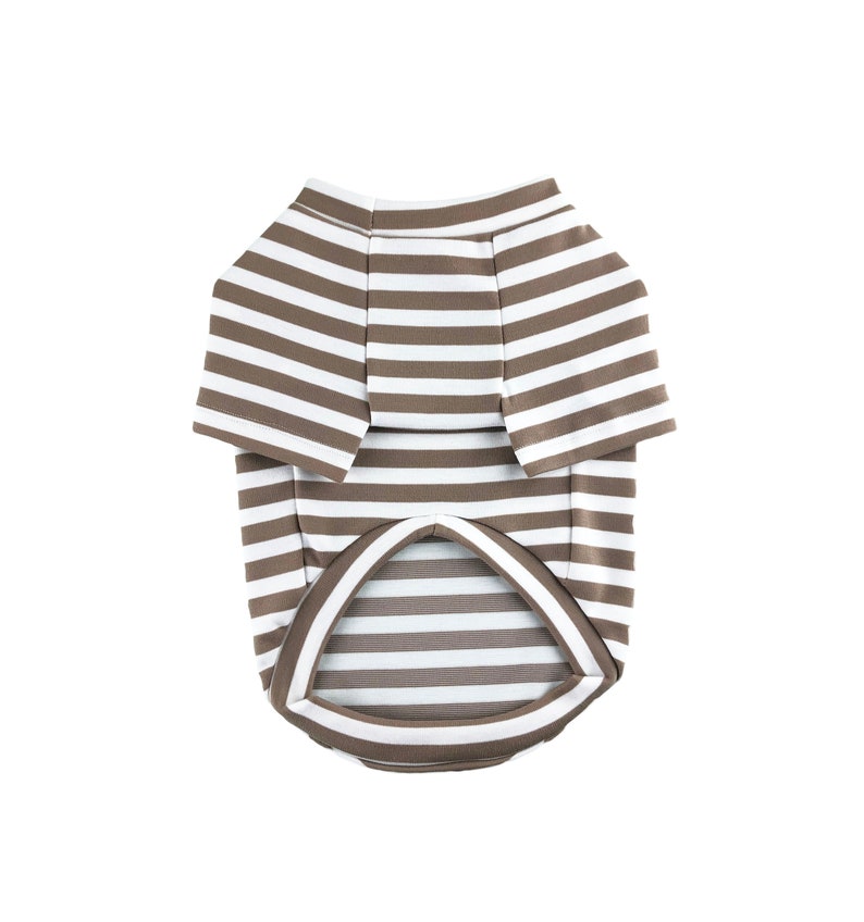 May include: A brown and white striped dog shirt with short sleeves.