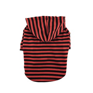 May include: Red and black striped hooded dog sweater.