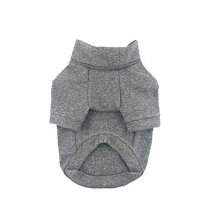 May include: A gray turtleneck sweater for a pet. The sweater has a ribbed collar and a long body.