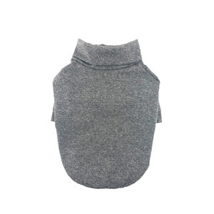 May include: A gray turtleneck sweater for a pet. The sweater is made of a soft, comfortable material and has a relaxed fit.