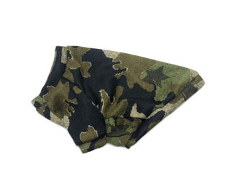 May include: Camouflage dog sweater with a star pattern in shades of green, brown, and black.