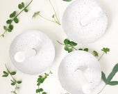 Speckled candle holder bowl in black and white. White eggshell glazed candle holder