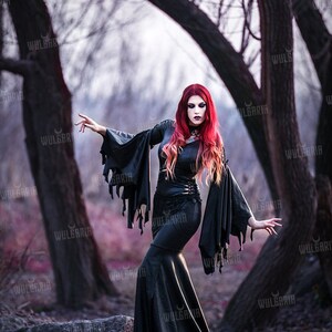 Model posing in dark fantasy gown in autumn woods