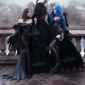 Group of models wearing gothic leather-look gowns outdoors