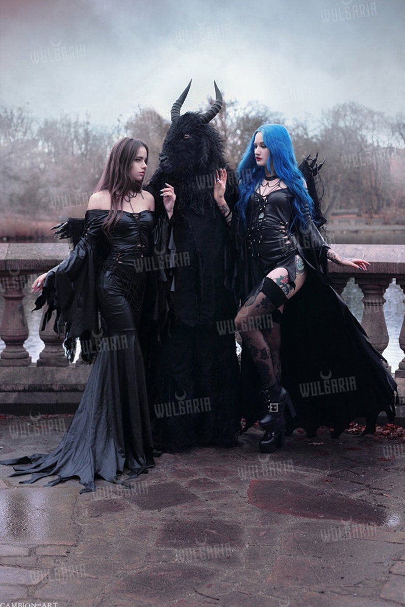 Group of models wearing gothic leather-look gowns outdoors