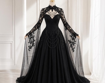 May include: A black formal gown with a high, lace-trimmed neckline and long, flowing sleeves. The bodice features intricate lace detailing and a beaded accent. The skirt is full and flowing, creating an elegant silhouette. The dress is displayed on a mannequin.