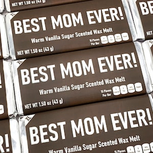 May include: A close-up of several brown wax melt bars with silver foil wrappers. The bars are labeled "Best Mom Ever!" and "Warm Vanilla Sugar Scented Wax Melt". Each bar is 1.50 ounces (43 grams).