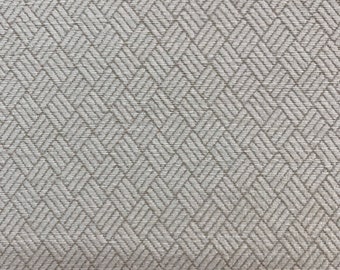 May include: A close-up of a white fabric with a subtle, woven herringbone pattern. The fabric has a slightly textured surface.