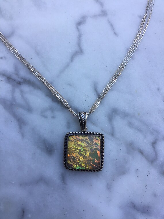 Tourquoise and Spring Green Spiral on black glass with rainbow dichroic glass center on sterling silver necklace by Deborah Tom