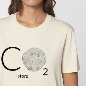 May include: A white t-shirt with a black graphic of a tree ring and the text "CO2 store".