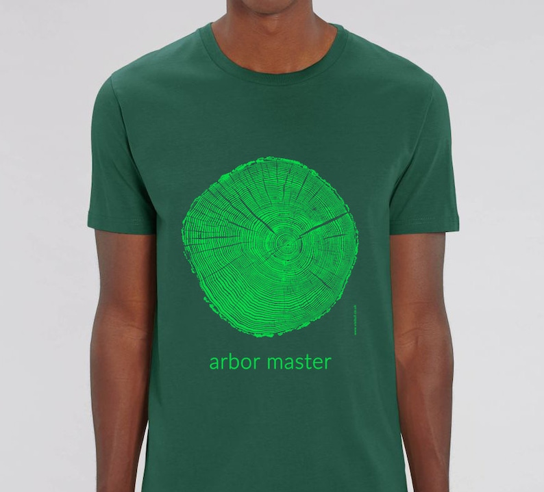 May include: A dark green t-shirt with a green tree ring graphic and the text "arbor master" printed on the front.