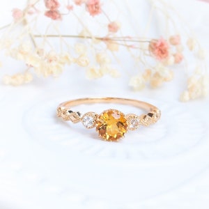 Delicate ring in 925 silver gilded with yellow gold, citrine and colorless topazes
