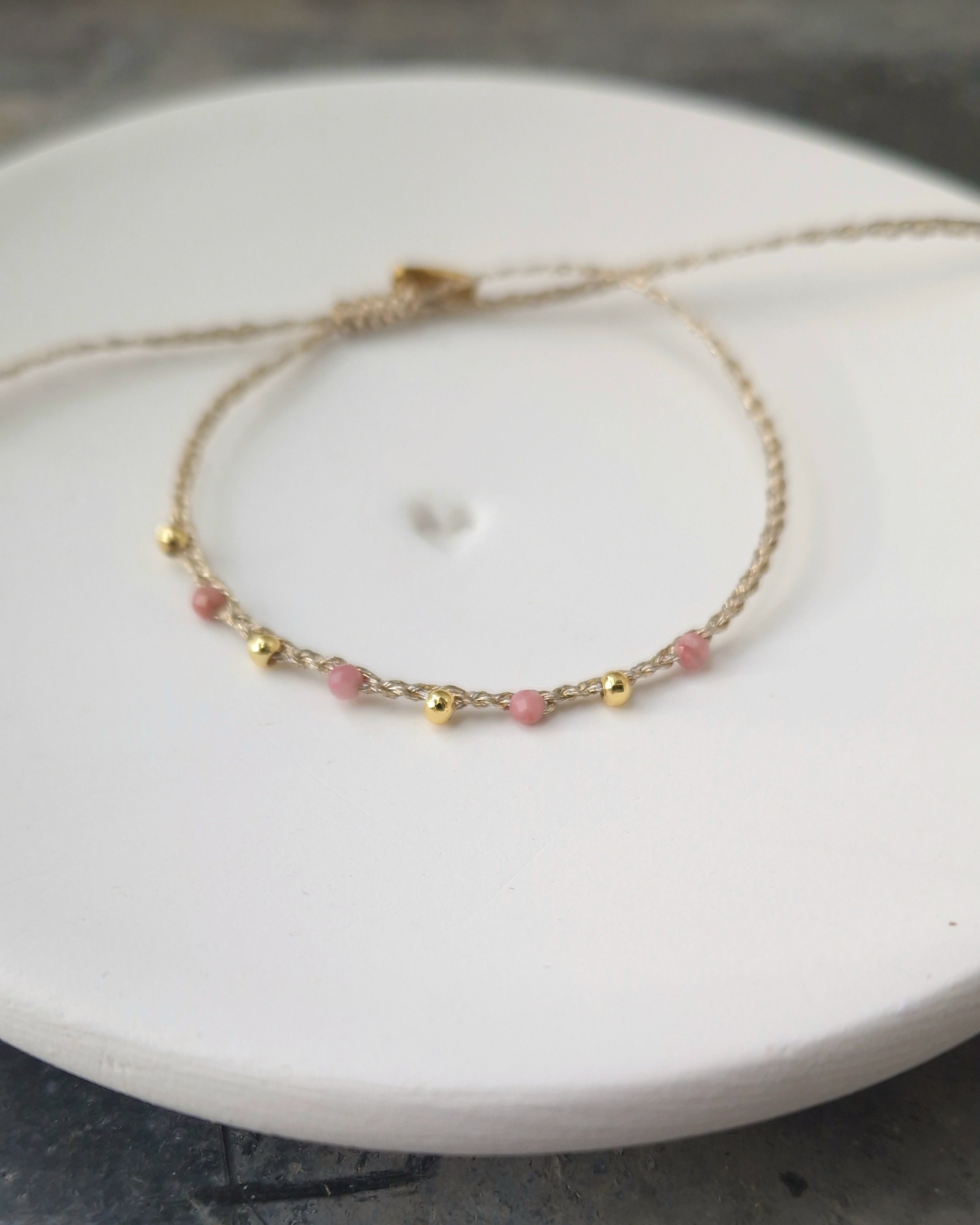 Adjustable golden braided wire and rhodochrosite bracelet