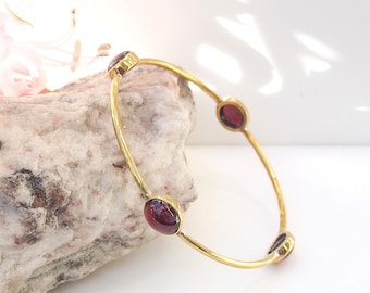 Brass bangle bracelet set with 4 oval cabochon red garnets