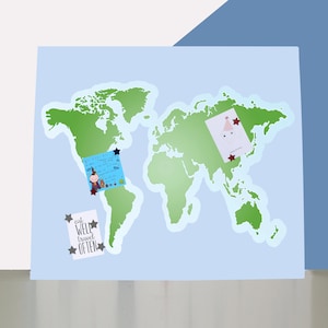 May include: A light blue world map with green continents. Three cards are pinned to the map with star-shaped push pins. One card has the text "eat well travel often". The other two cards have illustrations.