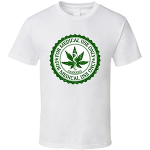May include: White t-shirt with a green distressed stamp that reads "For Medical Use Only* Cannabis *For Medical Use Only". The stamp features a marijuana leaf with a medical symbol.