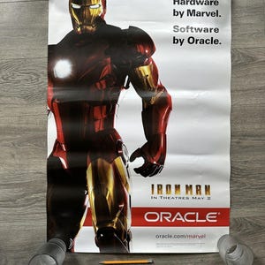 May include: A poster featuring Iron Man in red and gold armour. The poster includes the text "Hardware by Marvel. Software by Oracle." and "Iron Man in Theatres May 2" with the Oracle logo and website.
