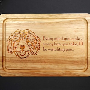 May include: A wooden chopping board with a laser-engraved image of a dog and the text "Every meal you make, every bite you take, I'll be watching you..."